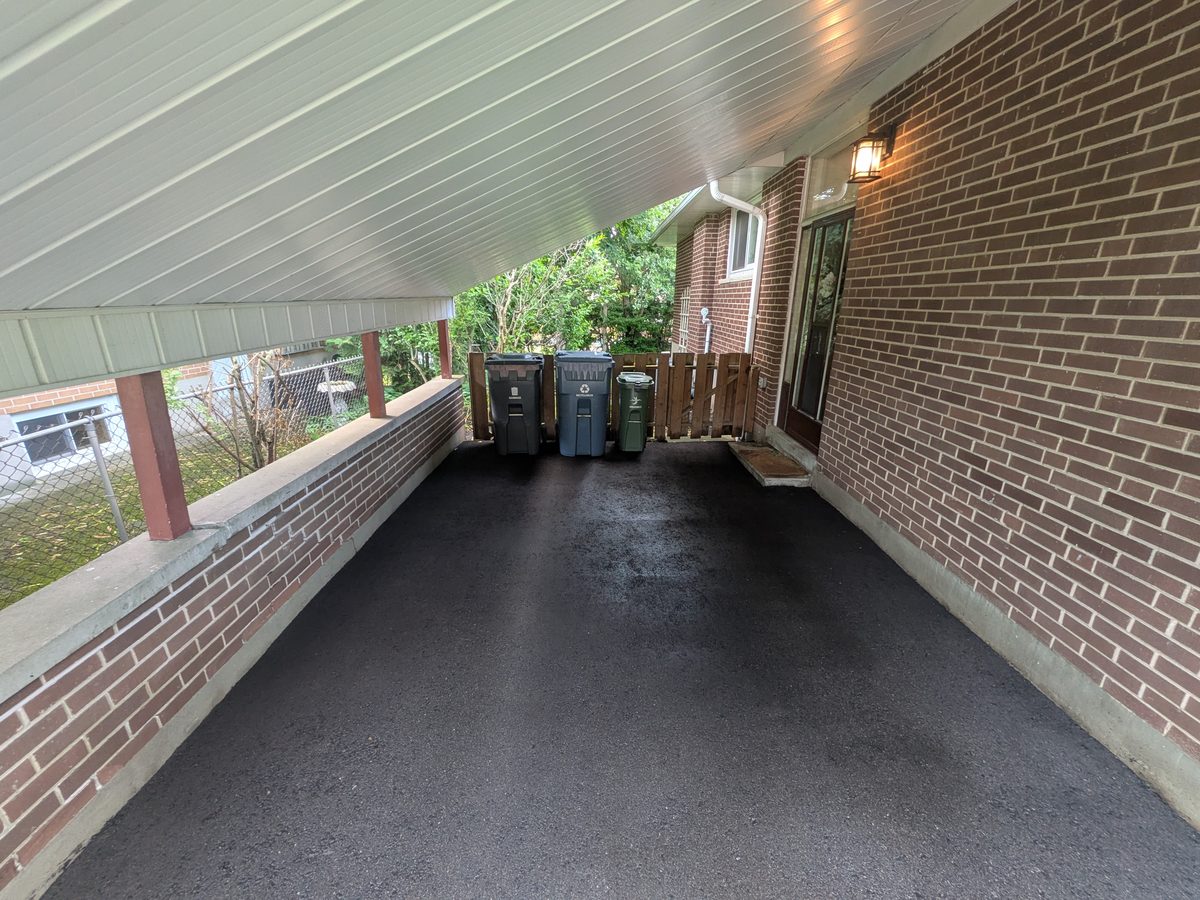 The same driveway cleaned to an even dark finish