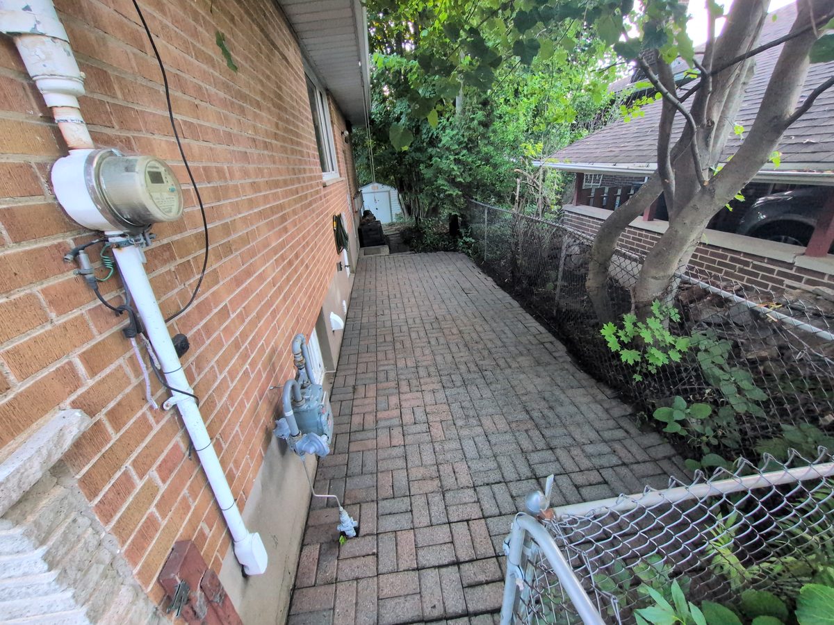 The same walkway cleaned, with the red brick pattern visible again